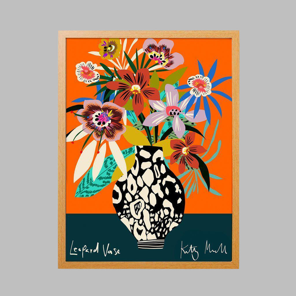 Leopard Vase fine art giclée print by Kitty McCall, featuring a bold black-and-white leopard spot vase overflowing with vibrant blooms, set against a striking orange background, perfect for adding playful elegance to modern home decor